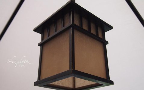 A square light hangs from the gazebo, the pespective point is below.